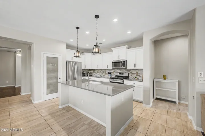 White Cabinets with Crown Molding, Stainless Steel Appliances, Quartz Counters, and Gas Stove!