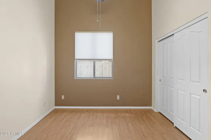 Guest room has painted accent wall to give dimension and vaulted ceilings