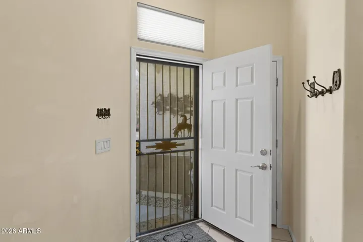 Living room entry with seasonal closet behind