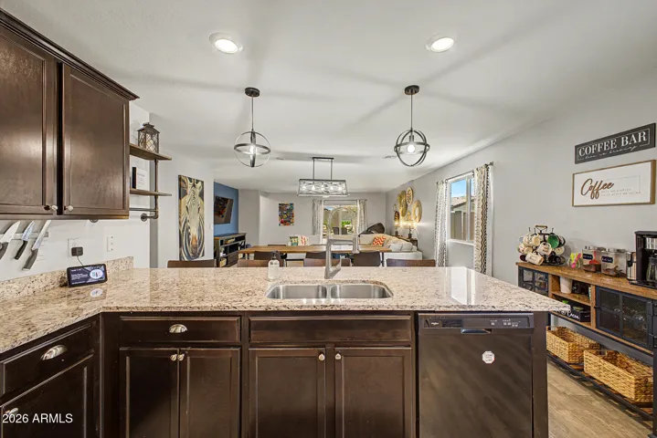 Granite countertops, an undermount sink, upgraded faucet, and custom lighting beautifully complete this kitchen.