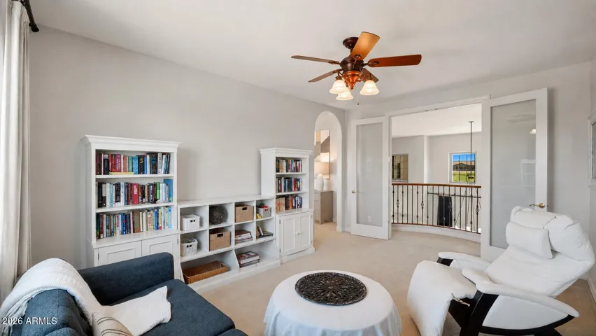 Double doors open to the Juliet balcony, bringing natural light and architectural charm into the flex space.