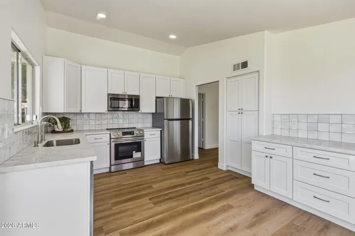 42-inch tall cabinets, quartz counters, on-trend (yet timeless) backsplash.