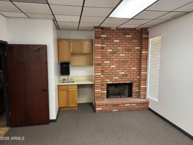 Large office at back of space with private entrance/exit dooropening to parking lot on west side of the building.