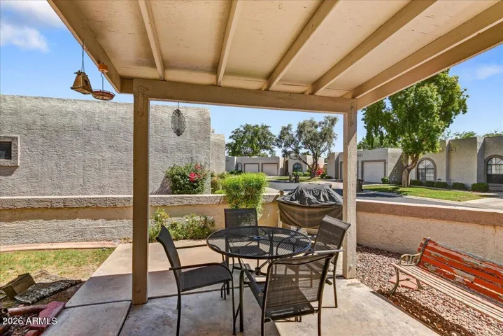A shaded back covered patio offers a perfect outdoor retreat for dining, relaxing, and enjoying the Arizona weather