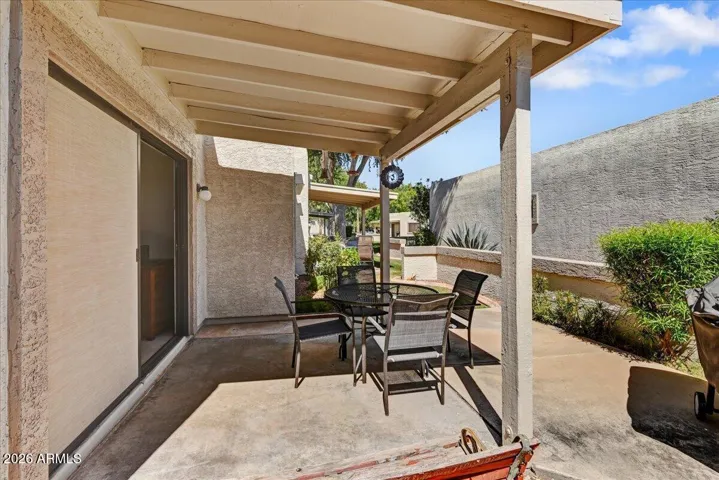 An extended view of the sturdy covered patio highlighting the transition to the open backyard space.