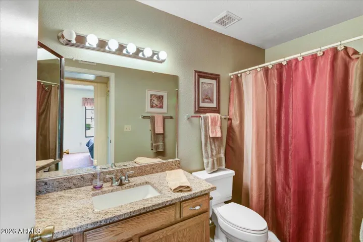 Guest bath also features granite counters and tub and shower combo