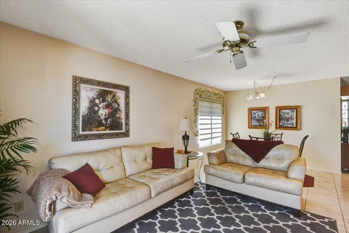 A wide view capturing the seamless transition from family room into the dining and kitchen spaces.