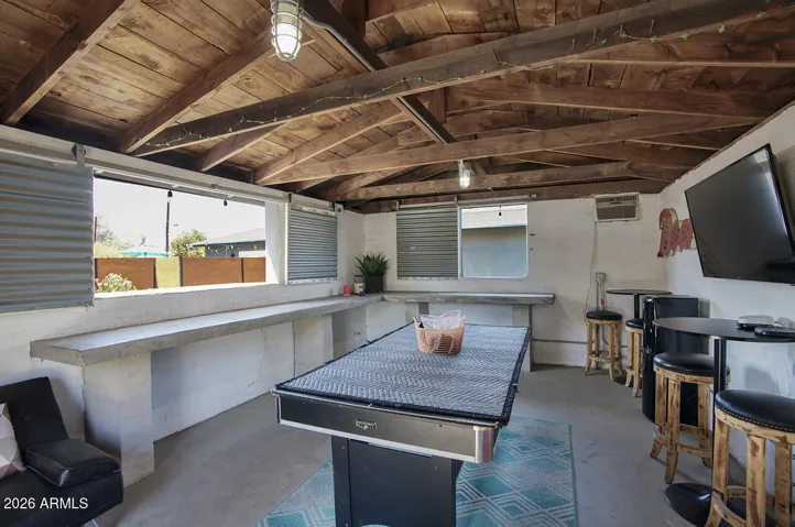 The outdoor structure is solid! Currently a fun game and hang out room, it could be turned into an outdoor kitchen or bar! Wall unit AC and barn door style window shutters.