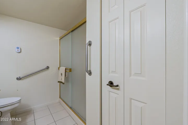 Large linen closet, roomy and grab bars for safety.