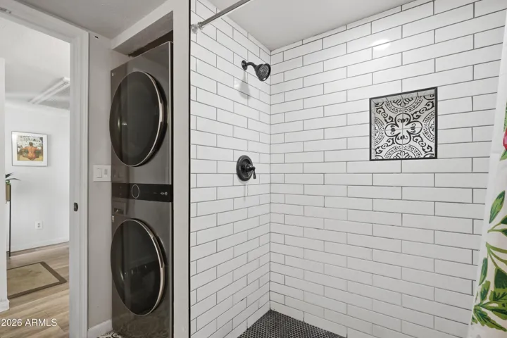 Stack washer and dryer and large walk-in shower.