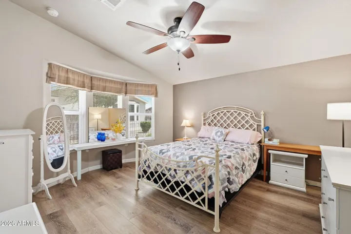 Large primary bedroom with bay windows.
