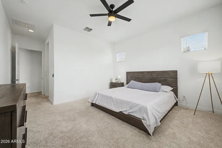 Primary suite w/ natural light, ceiling fan and neutral paint
