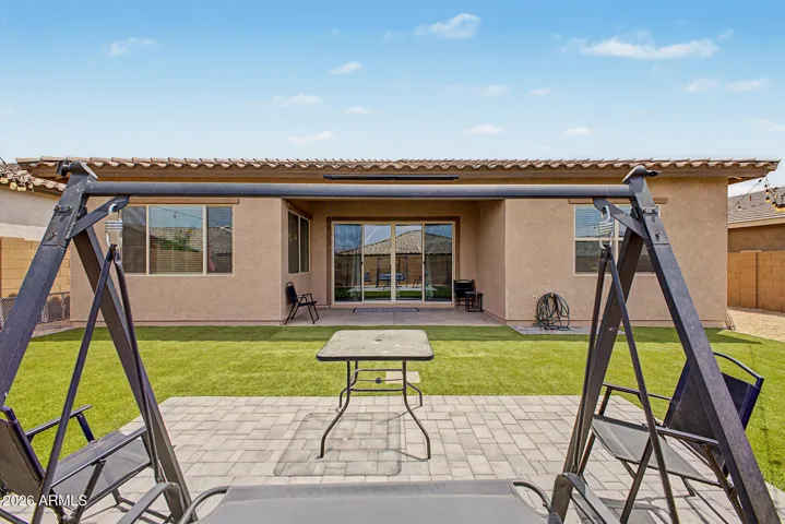 Covered patio, turf, paved seating area