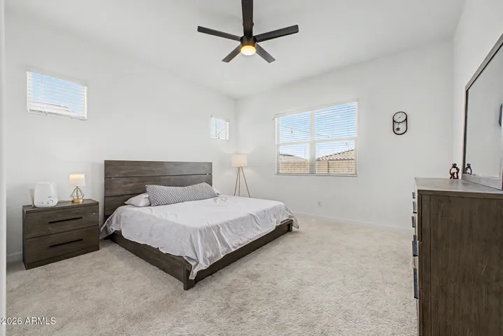 Primary suite w/ natural light, ceiling fan and neutral paint
