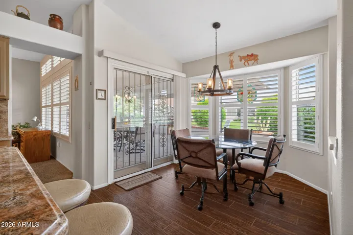 The breakfast room offers views of the grassy back yard and offers lots of natural lighting.