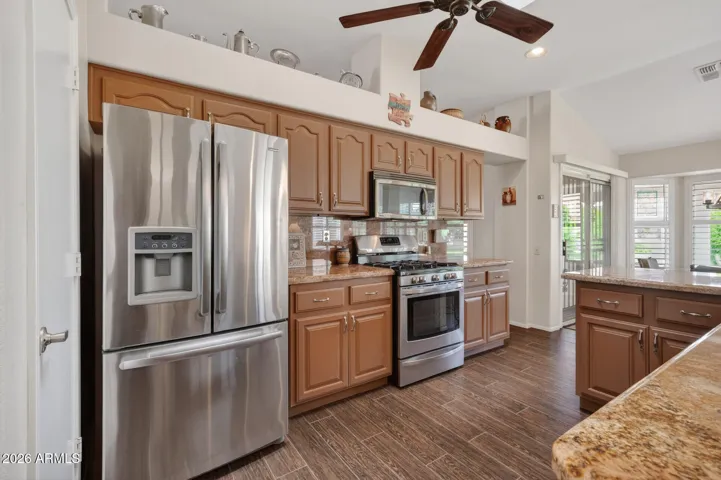 Notice the newer SS appliances & granite counters.