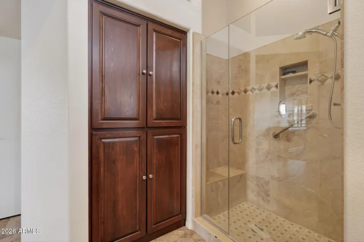 The easy entry shower and 4-door linen closet are features of the owner's bath.