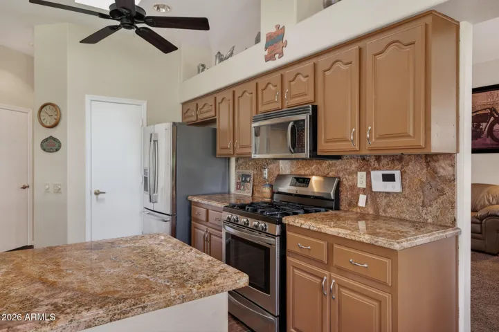 The door next to the refrigerator leads into the pantry.