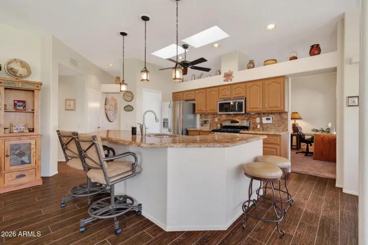 The kitchen is light and bright with a skylight and large island.