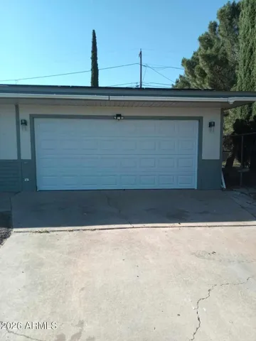 Spacious oversized 2 car garage with cooled window unit for garage & workroom w/extra refrigerator and separate freezer