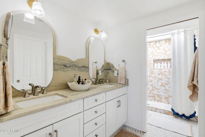Primary Bath Primary with hand carved quartite natural stone and the shower redefined with Moroccan tile