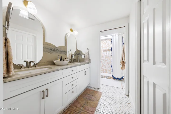 Primary Bath with hand carevd quartzite natural stone counertop and backsplash