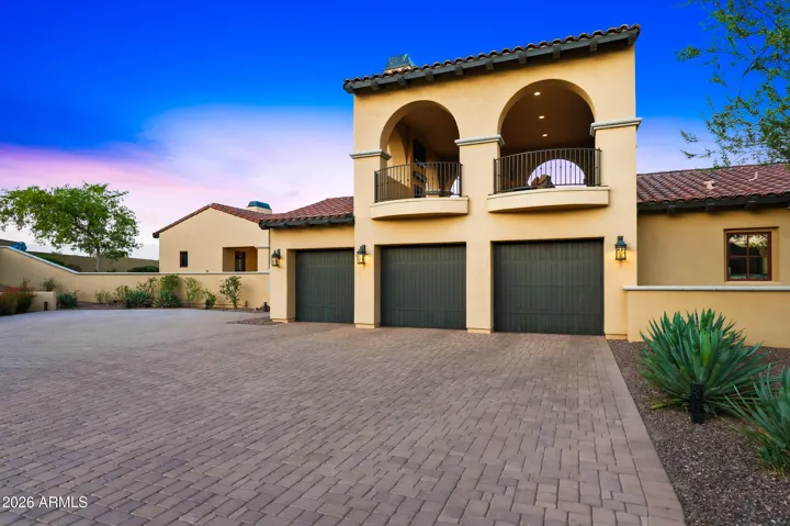 Three car garage with an oversized upper balcony capturing sweeping mountain and neighborhood views.
