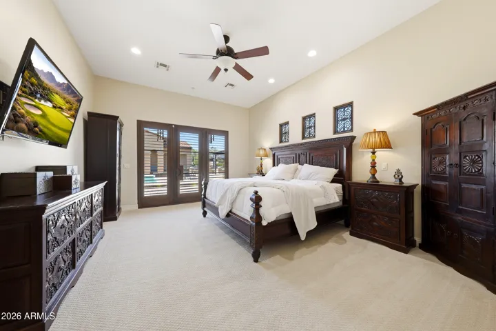 Spacious primary bedroom with private access to the backyard and pool area.