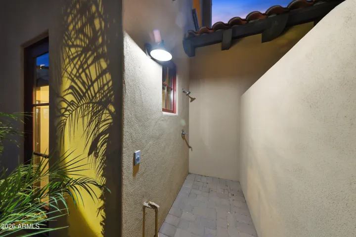 Convenient outdoor shower located just steps from the pool area.