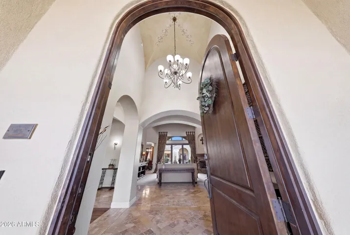 Impressive large arched wood front door creating a warm and elegant first impression.