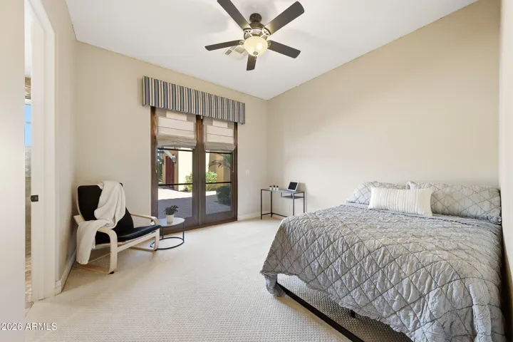 Bedroom three features direct access to the backyard and outdoor living spaces.