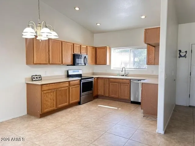 Kitchen with Electric Range, Microwave & Dishwasher.