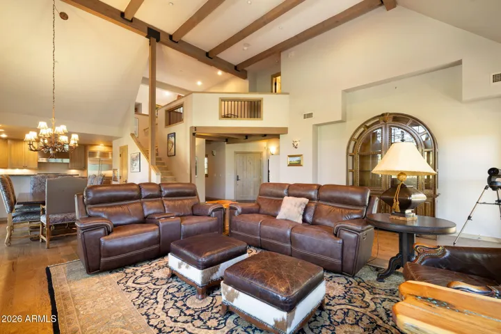 nice open living room with vaulted ceilings and log fireplace