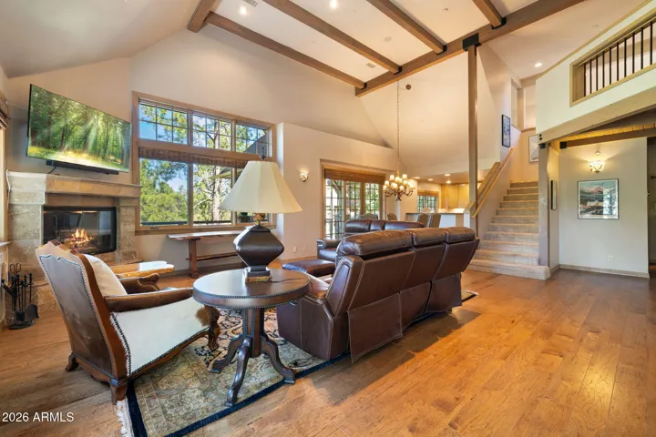 nice open living room with vaulted ceilings and log fireplace