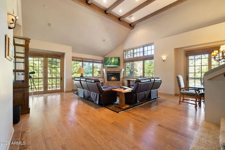 nice open living room with vaulted ceilings and log fireplace