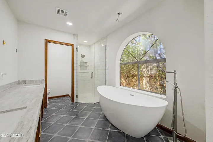 New Soaking Tub and Retiled shower with Glass Door