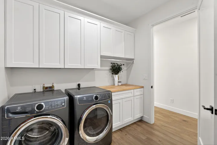Laundry room with master closet access