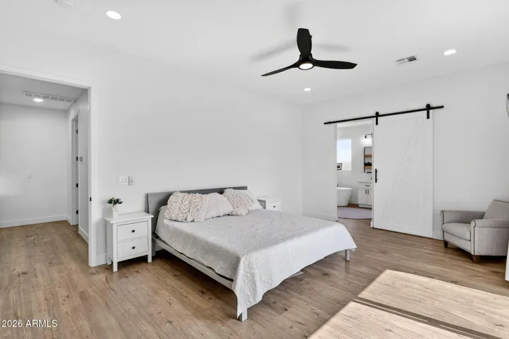Master bedroom with barn door to bathroom