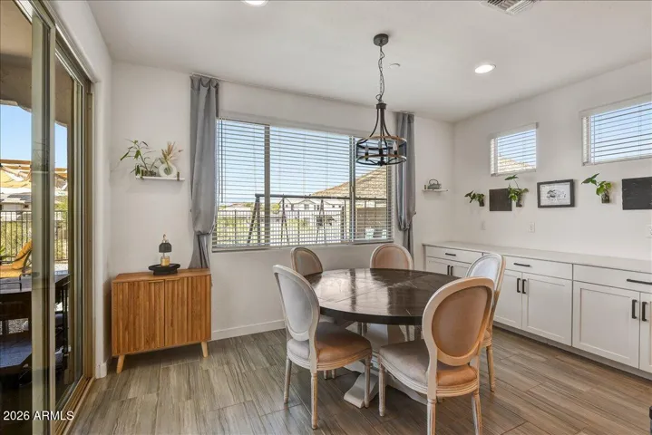 Perfectly situated between the kitchen and the backyard entry, this bright breakfast nook offers an ideal spot for casual everyday dining. Large windows and glass sliding doors flood the entire space with natural desert light.