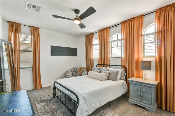 This comfortable upstairs bedroom offers great flexibility, a cooling ceiling fan, and neutral flooring. Ideally separated from the primary suite for added privacy, this room features its own dedicated en-suite bathroom, making it a perfect blank canvas for a guest suite or comfortable multi-generational living.