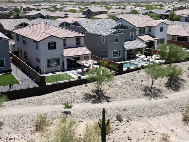 Emphasizing premium privacy and stunning open space, this vantage point from the adjacent wash highlights the home’s exceptional lot positioning.