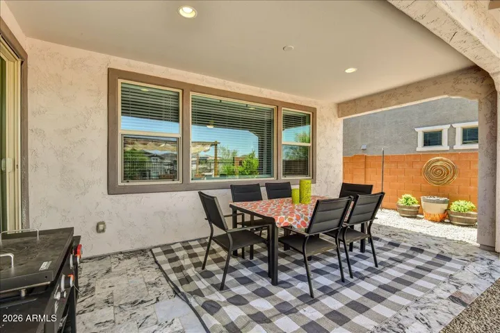 Step outside to a spacious, deep-set covered patio that acts as a natural extension of the indoor living space. Finished with clean tiling and recessed lighting, it offers a shady, protected footprint perfect for outdoor dining, lounging, or an expansive patio setup.