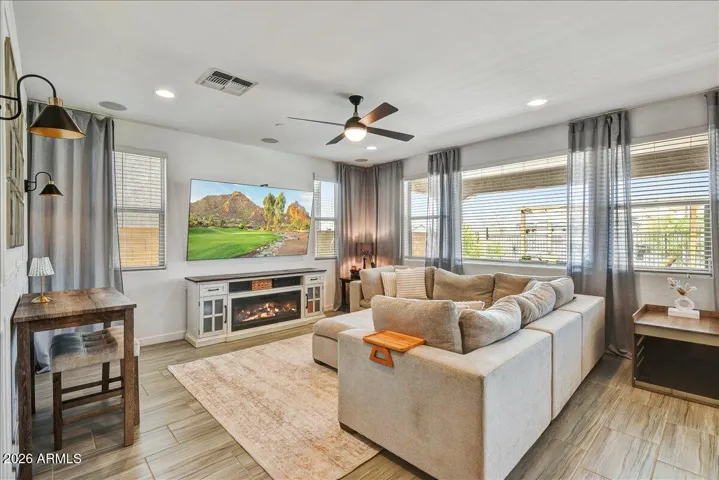 Another view of the main living area, highlighting its impressive depth, great window placements, and ideal flow for entertaining. The bright, neutral wall tones offer a versatile backdrop for any style of design.