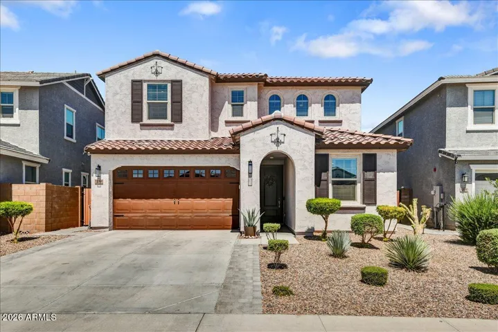 This beautiful two-story home boasts exceptional curb appeal, featuring a contemporary exterior with stone accents, a paved driveway, and meticulously designed low-maintenance desert landscaping.