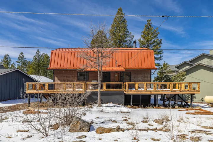 The spacious back deck offers the perfect setting to enjoy fresh mountain air and serene woodland views.