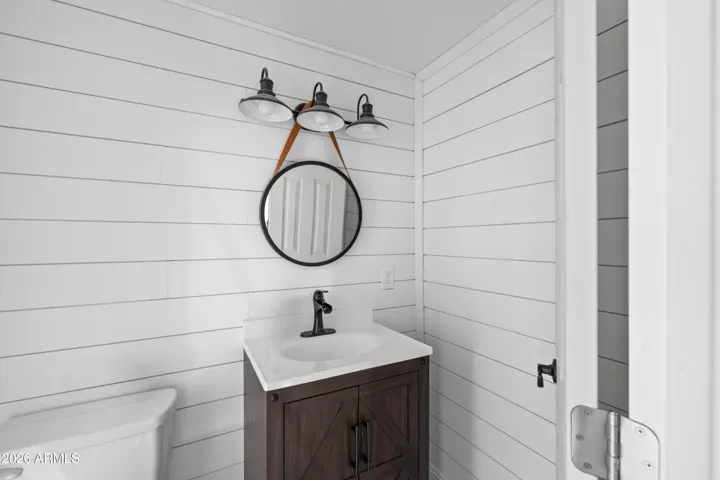 Bright bathroom with clean finishes and charm.