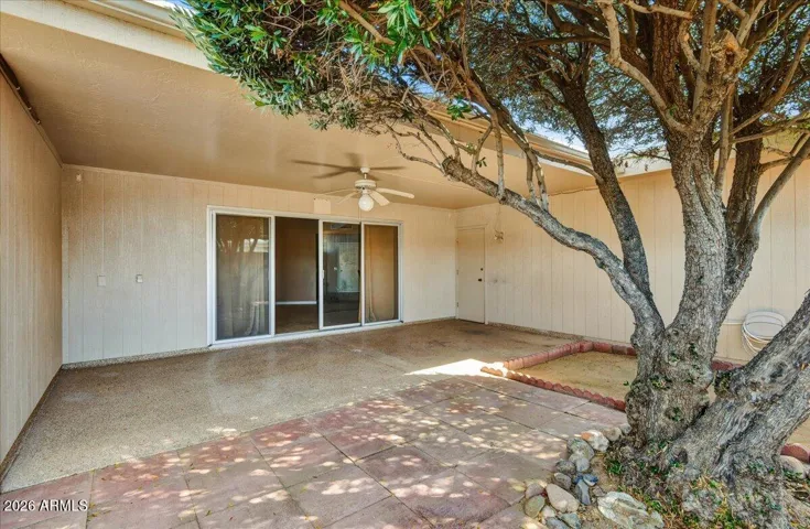 Wide-open backyard patio space offering plenty of room for outdoor furniture, a BBQ setup, and entertaining guests.