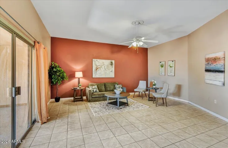 The versatile family room features tile flooring, showcasing the bright windows and flexible floor plan options.