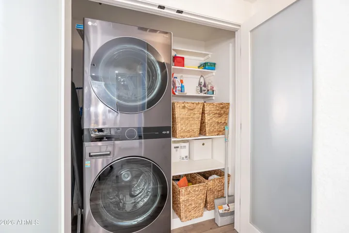 Energy Star Stacked Washer and Dryer with tons of storage. Beautiful arcadia doors with smoked glass panels.