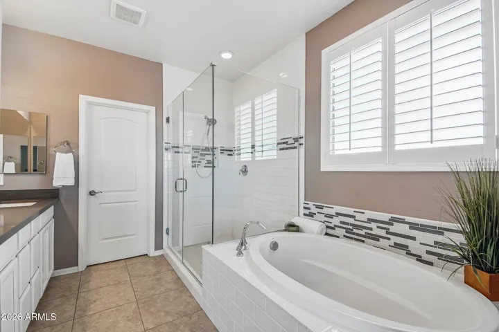 Sparkling primary bath with soaker tub, walk in shower & double vanity